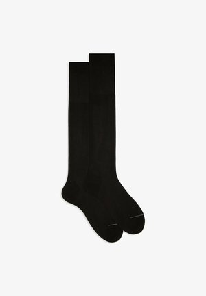 Black knee-high socks made of smooth fabric. Features a ribbed texture and reinforced toe with a subtle band detail near the top.