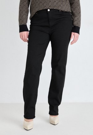 Black denim trousers with a straight-leg design, featuring a high waist and subtle stitching. Paired with light-colored block-heeled shoes.