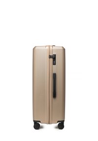 Gouden textuur hard-shell bagage met verticale ribbels, dubbele spinnerwielen, zijhandvat en combinatieslot voor veilige reis.