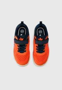 Bright orange athletic shoes with navy accents, breathable mesh upper, adjustable strap, and rubber soles. Size EU 28, UK 10.