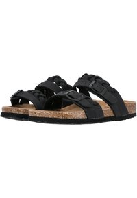 Schwarze geflochtene Sandalen mit Korkfußbett, verstellbaren Riemen und Gummisohlen. Sie verfügen über eine matte Textur und ein flaches Profil.
