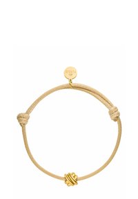 Knot-Armband aus einem beigen geflochtenen Band, verziert mit einem Knoten aus goldfarbenem Metall und einem runden Anhänger. Sanfte Textur mit minimalistischer Gestaltung.
