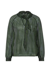 Blusa verde con maniche lunghe, caratterizzata da un dettaglio al collo con fiocco e un motivo testurizzato di macchie scure. Realizzata in tessuto leggero e trasparente.