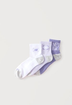 Tri páry členkových ponožiek v bielej a odtieňoch fialovej, každá so sivými špičkami a pätami a logami New Balance na manžetách.