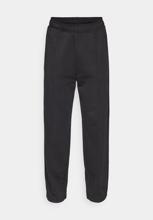 Black sweatpants made from soft fabric, featuring an elastic waistband, side seams, and tapered legs with cuffed hems.