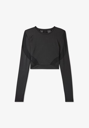 Maglia atletica nera a maniche lunghe con design cropped, realizzata in tessuto liscio con pannelli in rete sulle spalle e ai lati.