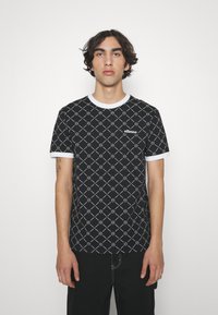 Black short-sleeve t-shirt with white geometric pattern and accents. Features a crew neckline and a small logo on the chest.
