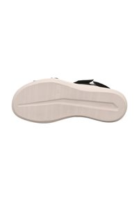 Schwarze Schuhsohle mit strukturiertem Grip-Muster, glatten Seiten und einer leichten Krümmung. Verfügt über eine weiße Außensohle mit Markenkennzeichnung.