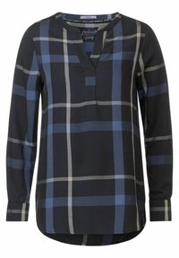 Blouse noire à manches longues avec un grand motif à carreaux bleus et gris, col rond avec une petite découpe en V, et poignets boutonnés.