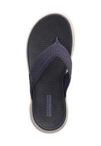 Navy blue flip-flop with woven strap and textured footbed, featuring a light-colored sole and subtle branding on the insole.