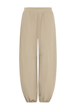 Pantalon beige à taille élastique, coupe ample, jambes droites et poignets élastiques froncés aux chevilles.