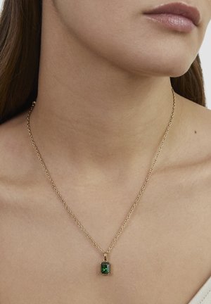 Gold chain necklace with a rectangular green gemstone pendant, featuring a smooth surface and fine link design.