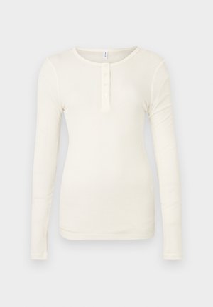 Μπλουζάκι henley μακρυμάνικο σε εκρού χρώμα, κατασκευασμένο από ριμπ ύφασμα, με στρογγυλή λαιμόκοψη και πατιλέτα με τέσσερα κουμπιά.