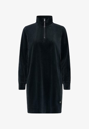 Vestido de pana verde oscuro con un alto cuello y cierre de cuarto, que presenta mangas largas y un ajuste relajado. Textura suave con rayas verticales.