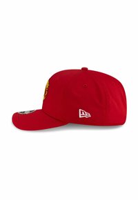 Red baseball cap with a curved visor, featuring embroidered logo details on the front and a small white brand logo on the side.