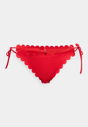 Piros bikini alsó hullámos szélével, állítható megkötőkkel az oldalán és sima textúrával. Az anyag rugalmasnak és könnyűnek tűnik.