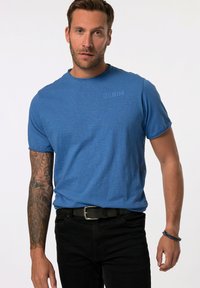 Modré tričko s krátkým rukávem a kulatým výstřihem, s jemným potiskem "DENIM" na hrudi. Nosit s černými kalhotami a opaskem.