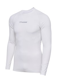 Långärmad sporttröja i vitt, tillverkad av elastisk tyg. Har rund halsringning och grått logotyp på framsidan. Slät textur, figurnära design.