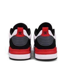 Black, red, and white sneakers with a textured panel design, featuring a padded collar and red accents on the heel and sole.