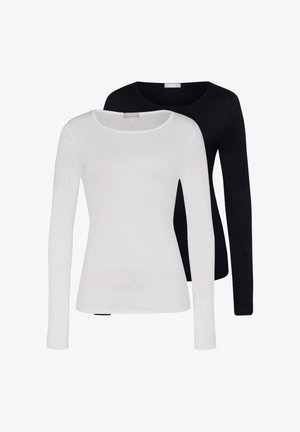 Deux hauts à manches longues unis pour femmes, un blanc devant et un noir derrière, tous deux avec un col rond.