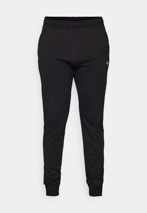 Schwarze Sweatpants aus weichem Stoff mit elastischem Bund und gerippten Knöcheln. Enthält ein kleines Logo an der unteren Beinpartie.