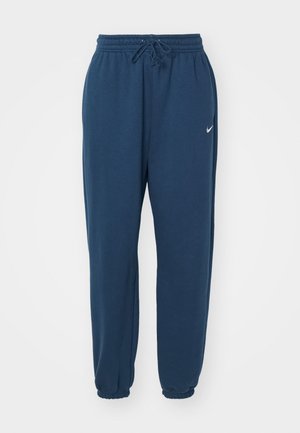 Pantalones de chándal azul marino hechos de tela suave, con una cintura elástica con cordón y un pequeño logo blanco de Nike en el lado izquierdo.
