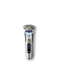 Il rasoio Philips Serie 9000 presenta un design ergonomico argento e nero, tre teste di rasatura circolari e un display illuminato per il livello di carica della batteria.