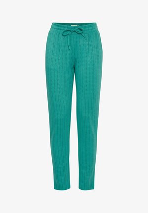 Turkusowe spodnie dresowe z elastycznym paskiem i sznurkiem do regulacji, z delikatnymi pionowymi prążkami oraz dwiema bocznymi kieszeniami dla funkcjonalności.