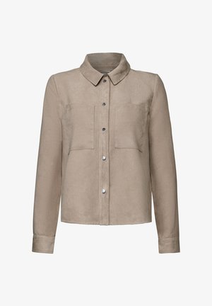 Beige corduroy shirt jacket with a collared neck, long sleeves, two chest pockets, and silver button closures. Soft texture and ribbed pattern.