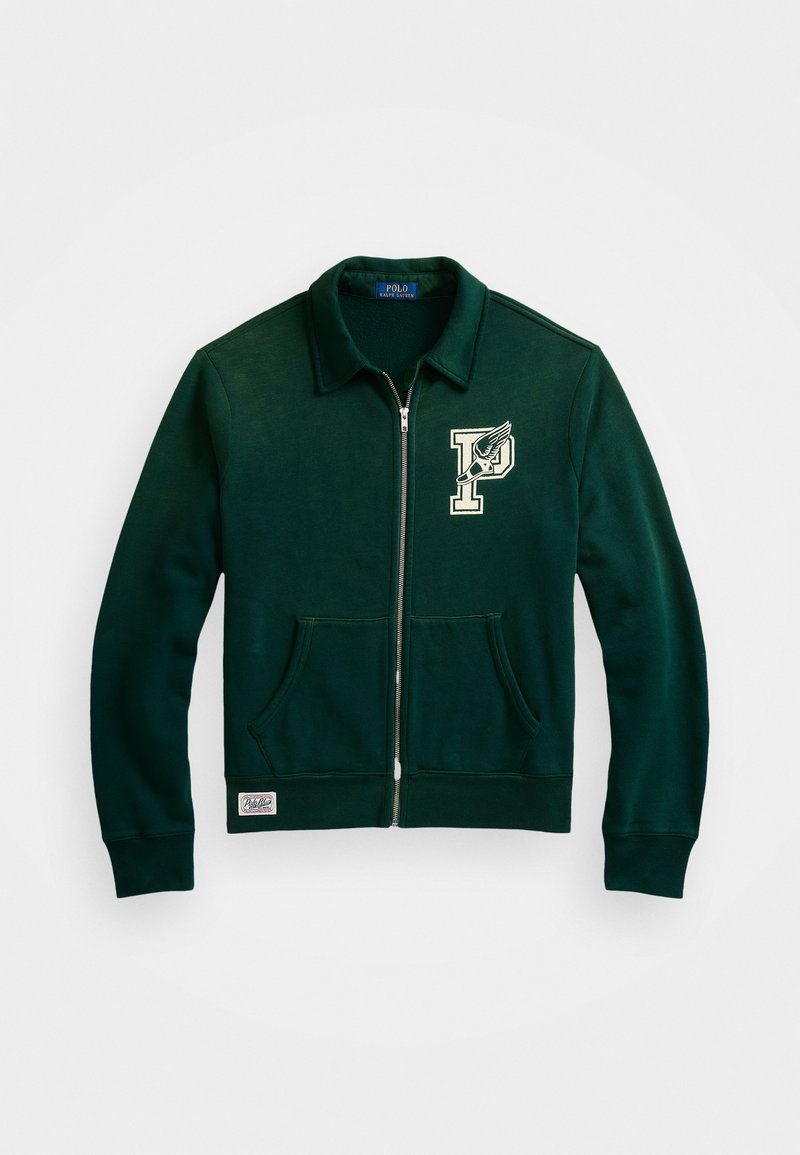 Green zip-up sweatshirt with a collar, featuring a logo patch and two front pockets. Soft fabric with a smooth texture.