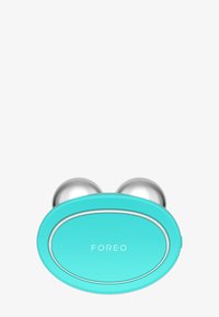 Appareil facial turquoise avec deux embouts sphériques argentés, un corps lisse et arrondi, et un petit logo ovale portant la mention "FOREO."