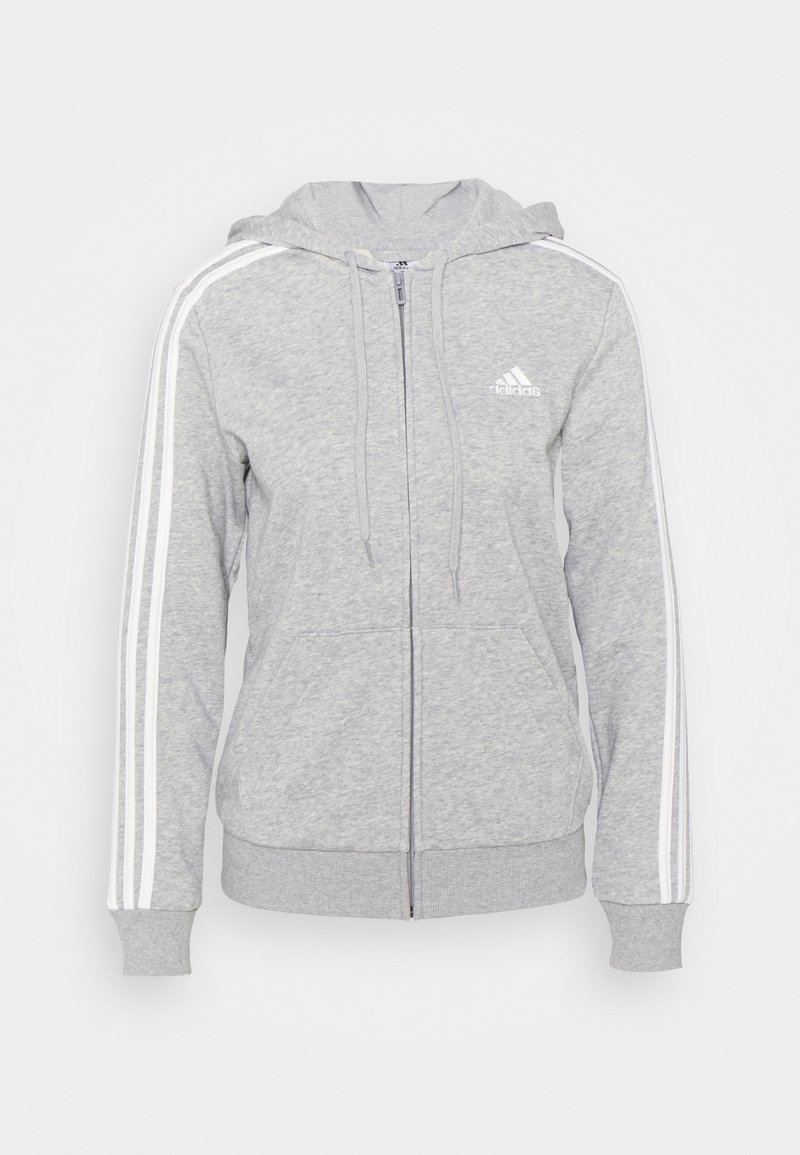 Šedá mikina s kapucí na zip vyrobená z měkké látky, má kapuci, přední kapsy a bílé pruhy na rukávech. Logo Adidas na hrudi.