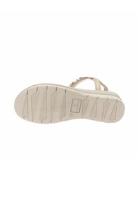 Sandalo beige con suola in gomma testurizzata e motivo scanalato. Le cinghie sono decorate con piccoli elementi ornamentali.