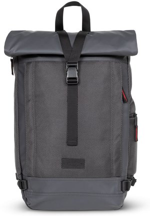 Gray roll-top backpack with a textured fabric, adjustable straps, and buckle closure. Features side pockets and a branded patch.