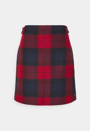 Spódnica w kratę tartan w kolorze czerwonym i granatowym z wysokim stanem i guzikami po obu stronach, długość do kolan, prosty krój.