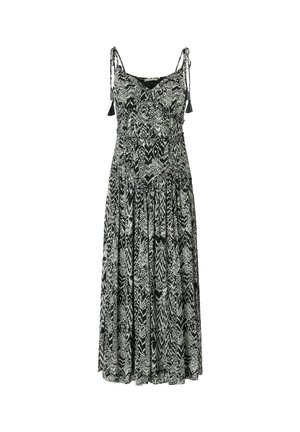 Zwart-witte mouwloze maxi-jurk met abstract zigzagpatroon en bindbandjes met kwastjes op de schouders.
