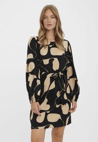 Black and beige patterned dress with long sleeves, tie waist, and elastic cuffs, featuring an abstract design and soft fabric texture.