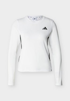 T-shirt de sport à manches longues blanc avec logo Adidas noir sur la poitrine et panneaux latéraux noirs, conçu pour l'entraînement.
