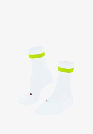 White ankle socks featuring a thick fluorescent yellow band at the top and red branding on the soles. Soft, smooth texture.