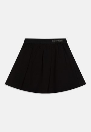 Black skirt featuring a gathered design with a smooth texture and elastic waistband branded with "Calvin Klein".