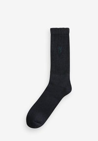 Marineblaue, gerippte Knöchelsocke aus weichem Material mit strukturiertem Finish, versehen mit einem dezenten Logo im oberen Bereich. Glatte Zehenpartie.