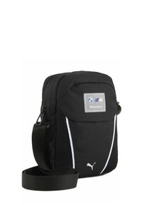Czarna torba na ramię z teksturowanym materiałem, białymi akcentami i logo BMW Motorsport. Posiada regulowany pasek oraz zamek błyskawiczny.