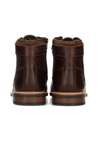 Braune Leder-Stiefeletten mit rundem Zehenbereich, doppeltem Reißverschluss, kontrastierenden Nähten und Gummisohle. Glatte Oberfläche mit minimalen Akzenten.