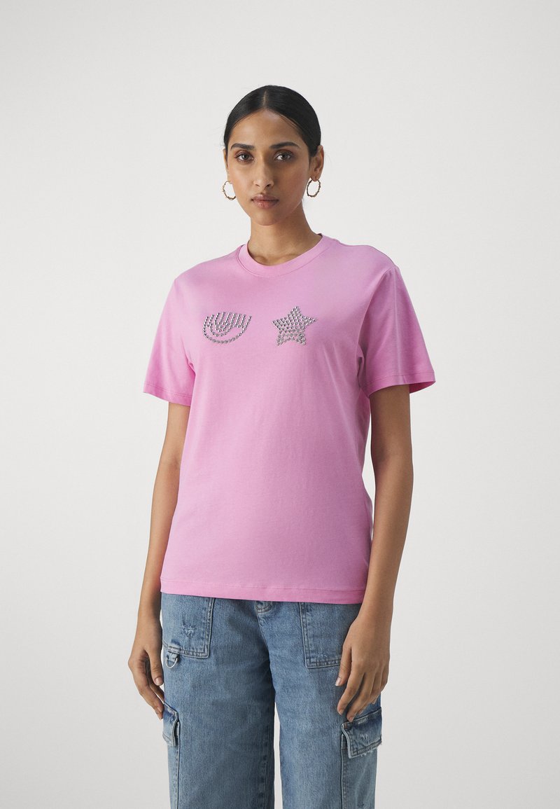 Pink cotton t-shirt featuring a ribbed round neckline, short sleeves, and embellishments of a curved line and star in rhinestones.