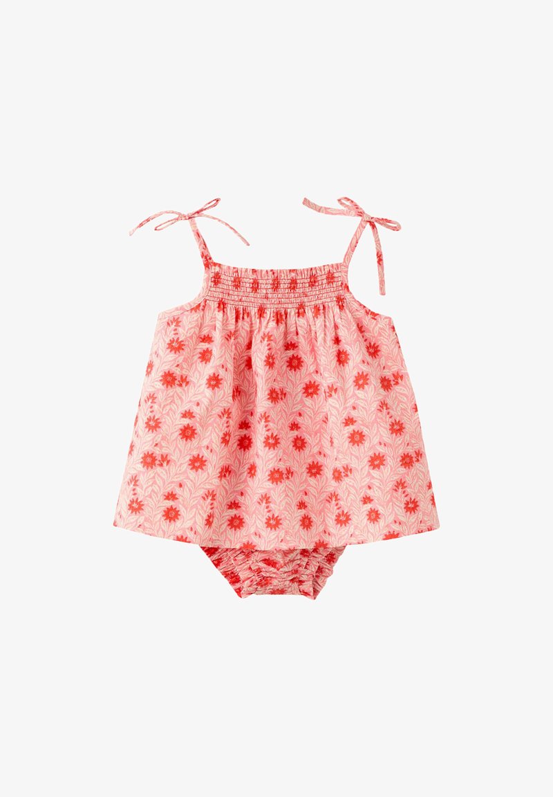 Pink sleeveless baby dress with red floral pattern and matching bloomers, featuring tie straps at the shoulders and elastic waist on bloomers.