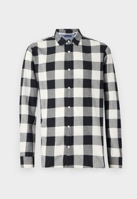 Camicia a maniche lunghe a scacchi in bianco e nero. Realizzata in un tessuto leggero con bottoni sulla parte anteriore e colletto classico.