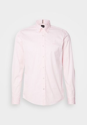 Light pink button-up shirt with white vertical stripes, long sleeves, and a classic collar. Features a small logo on the chest.