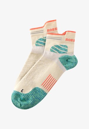 Calcetines de longitud de tripulación en color crema con acentos verdes. Presentan un patrón de rayas, un tejido texturizado y una puntera acolchada. Tamaño etiquetado como "L".