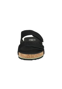 Black sandal with two overlapping suede straps, cork sole, textured footbed, and a contrasting light green trim around the base.