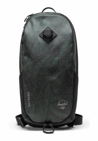 Sac à dos vert foncé avec une surface texturée et à motifs. Doté d'une poche en losange noire et de poches latérales en maille noire. Fermeture éclair.